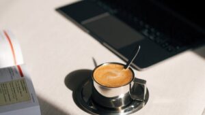 Coffee Cup and Laptop on Desk