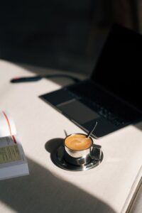 Coffee Cup and Laptop on Desk